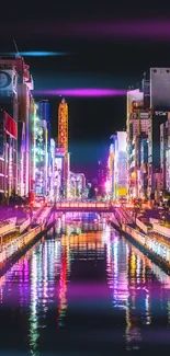 Vibrant neon cityscape reflected on water at night, showcasing colorful lights.