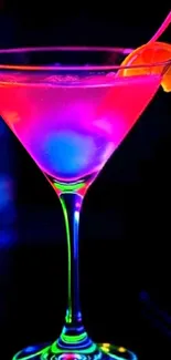 Vibrant neon cocktail with a citrus garnish in a dark setting.