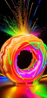 Vibrant neon donut with colorful splash on a black background.