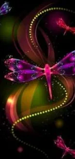 Vibrant neon dragonfly design on a dark background.