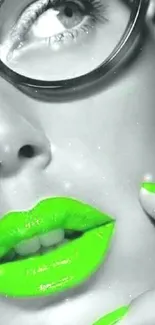 Bold wallpaper with neon green lips and nails on a monochrome face.