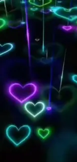 Neon hearts glowing in vibrant colors on a black background.