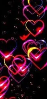 Vibrant neon hearts on a dark background wallpaper.