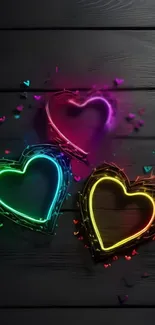 Neon hearts wallpaper with glowing colors on dark background.