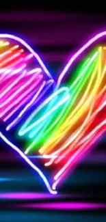 Vibrant neon heart with rainbow colors on black background.