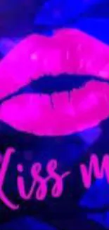 Neon pink kiss with 'Kiss Me' text on dark blue background.