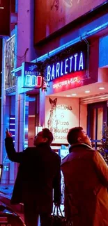 Neon-lit urban street scene at night with vibrant colors.