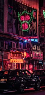 Vibrant neon-lit city street at night with cars and shops.