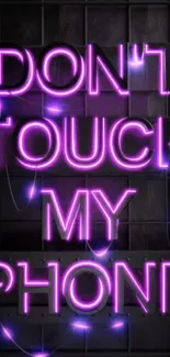 Neon sign reads "Don't Touch My Phone" on dark background.