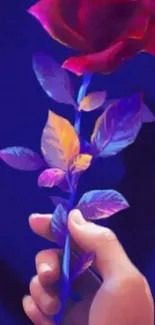 Neon rose against a deep blue background, held delicately in a hand.