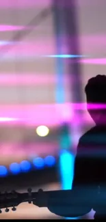 Silhouette of a guitarist with neon lights.