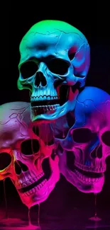 Vibrant neon skulls with gradient hues on dark backdrop wallpaper.