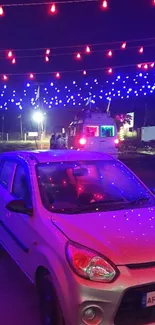 Car parked under vibrant red and blue lights at night.