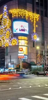 Vibrant night cityscape with illuminated buildings and festive lights.