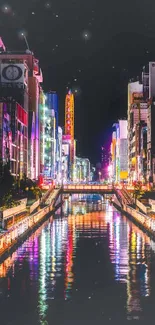 Vibrant cityscape at night with colorful reflections in the canal.