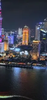 A vibrant city skyline illuminated at night with colorful reflected lights.