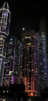 Illuminated skyscrapers at night in vibrant cityscape.