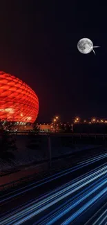 Vibrant cityscape with red architecture and highway at night under a bright moon.