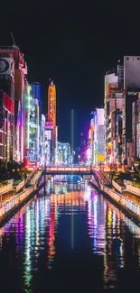 Illuminated cityscape with vibrant neon reflections on water.