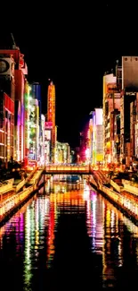 Vibrant cityscape with colorful reflections on a night canal.