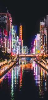 Colorful cityscape at night with vibrant neon lights reflecting on water.