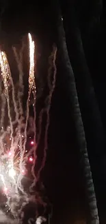 Fireworks exploding in a dark sky with vibrant lights and smoke trails.