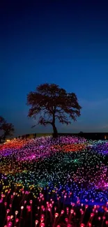 Vibrant night landscape with colorful lights and deep blue sky.