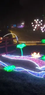 Vibrant lantern display with glowing lotus flowers at night.