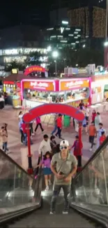 Escalator view overlooking a lively night market.