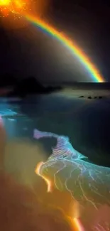 Vibrant rainbow over a glowing ocean shore at night.