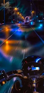 Nighttime motorcycle ride with vibrant city lights.