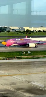 Colorful Nok Air jet on airport runway.