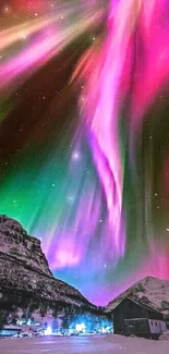 Vibrant aurora borealis over snow-capped mountains at night.