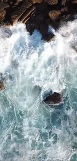 Aerial view of powerful ocean waves crashing against rocks.