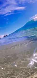 Ocean wave rolling under a clear blue sky.