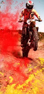 Motocross biker with vibrant red color splash on a dirt path.