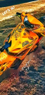 Vibrant orange motorcycle wallpaper with artistic decals and designs.