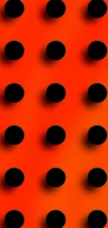 Orange wallpaper with bold black polka dots.