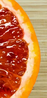 Close-up of a vibrant orange slice on a wooden background.