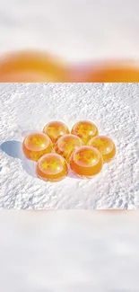 Orange spheres on snowy background wallpaper.