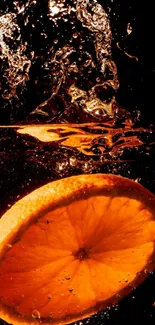 Orange slice splashing into dark water background.