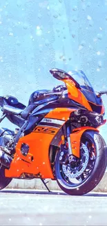 Orange sport bike mobile wallpaper with bright sky background.