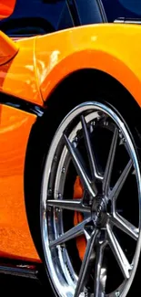 Close-up of a vibrant orange sports car with sleek rims, perfect for car enthusiasts.