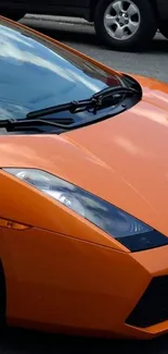 Vibrant orange sports car wallpaper for mobile screens.