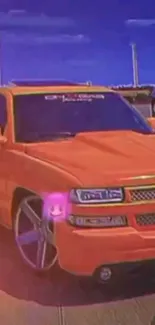 Vibrant orange truck on street with bold colors, perfect for mobile wallpaper.