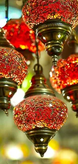 Vibrant red mosaic oriental lamps against a blurred background.