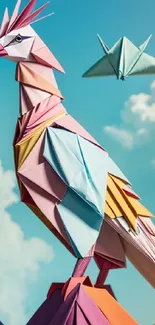 Origami bird art with pastel colors on a sky background.