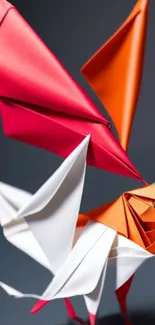 Vibrant origami bird with red and orange wings in artistic design.