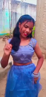 Girl dancing outdoors in blue dress