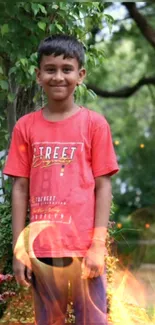 Smiling boy in red shirt with fiery effect against green background.